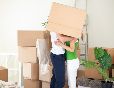 Local moving team carrying furniture through a Dulwich property